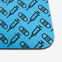 A close-up of the blue classic mousepad with a black pattern of bandages and vaccines