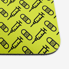 A close-up of the green classic mousepad with a black pattern of bandages and vaccines