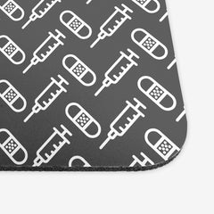 A close-up of the grey classic mousepad with a white pattern of bandages and vaccines
