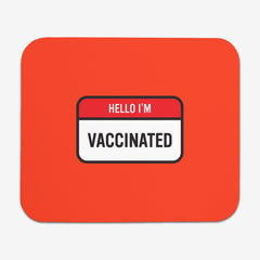A red classic mousepad with a red and white label at the center. The red part of the label says "Hello I'm" in white text. The white part of the label reads "Vaccinated" in black text.