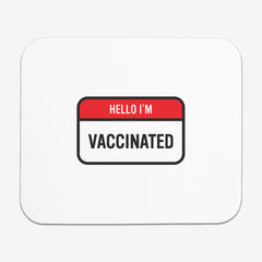 A white classic mousepad with a red and white label at the center. The red part of the label says "Hello I'm" in white text. The white part of the label reads "Vaccinated" in black text.