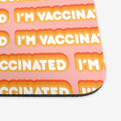A close-up of a pink classic mousepad with an orange and white bubble text pattern. The text that reads “I’m Vaccinated” is in white. Each of these has orange behind them, from the lightest shade to the darkest shade.