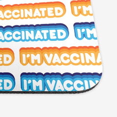 A close-up of a white classic gaming mousepad with an orange, blue, and white bubble text pattern. The text that reads “I’m Vaccinated” is in white. Each of these has orange or blue behind them, from the lightest shade to the darkest shade.