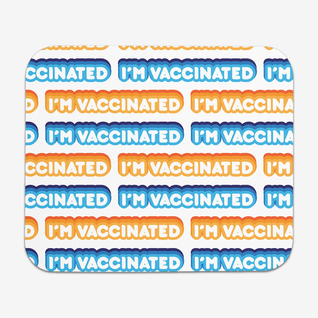 A white classic mousepad with an orange, blue, and white bubble text pattern. The text that reads “I’m Vaccinated” is in white. Each of these has orange or blue behind them, from the lightest shade to the darkest shade.