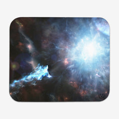 Classic mousepad of Going Beyond Light by Martin Kaye. An abstract space scene. There is a large whit explosion to the right side of green, blue, and white stars.