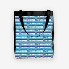 A blue day tote with a blue and white bubble text pattern. The text that reads “I’m Vaccinated” is in white. Each of these has blue behind them, from the lightest shade to the darkest shade.