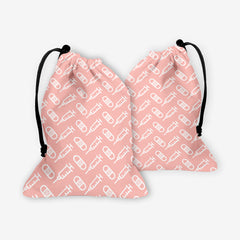 A front and back side of a pink dice bag with a white pattern of bandages and vaccines.