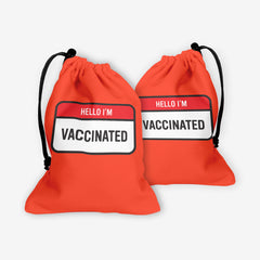 A front and back side of a red dice bag with a red and white label at the center. The red part of the label reads “Hello I’m” in white text. The white part of the label reads “Vaccinated” in black text.