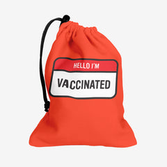 A red dice bag with a red and white label at the center. The red part of the label reads “Hello I’m” in white text. The white part of the label reads “Vaccinated” in black text.