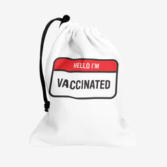 A white dice bag with a red and white label at the center. The red part of the label reads “Hello I’m” in white text. The white part of the label reads “Vaccinated” in black text.