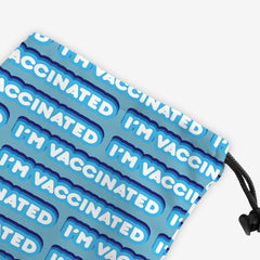 A close-up of a blue dice bag with a blue and white bubble text pattern. The text that reads “I’m Vaccinated” is in white. Each of these has blue behind them, from the lightest shade to the darkest shade.