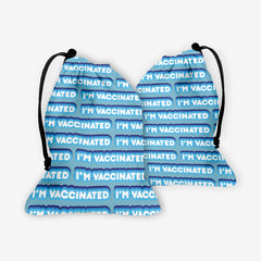 A front and back side of a blue dice bag with a blue and white bubble text pattern. The text that reads “I’m Vaccinated” is in white. Each of these has blue behind them, from the lightest shade to the darkest shade.