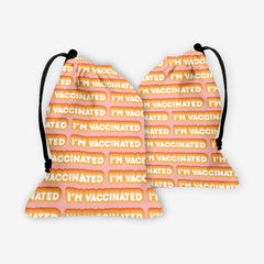 A front and back side of a pink dice bag with an orange and white bubble text pattern. The text that reads “I’m Vaccinated” is in white. Each of these has orange behind them, from the lightest shade to the darkest shade.