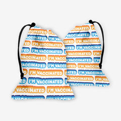 A front and back side of a white dice bag with an orange, blue, and white bubble text pattern. The text that reads “I’m Vaccinated” is in white. Each of these has orange or blue behind them, from the lightest shade to the darkest shade.