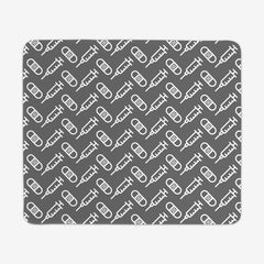 A grey large gaming mousepad with a white pattern of bandages and vaccines