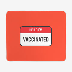 A red large gaming mousepad with a red and white label at the center. The red part of the label says "Hello I'm" in white text. The white part of the label reads "Vaccinated" in black text.