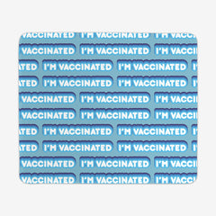 A blue large gaming mousepad with a blue and white bubble text pattern. The text that reads “I’m Vaccinated” is in white. Each of these has blue behind them, from the lightest shade to the darkest shade.
