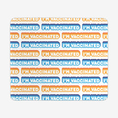 A white large gaming mousepad with an orange, blue, and white bubble text pattern. The text that reads “I’m Vaccinated” is in white. Each of these has orange or blue behind them, from the lightest shade to the darkest shade.