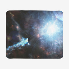 Large gaming mousepad of Going Beyond Light by Martin Kaye. An abstract space scene. There is a large whit explosion to the right side of green, blue, and white stars.