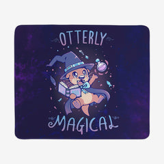 Extra Large Gaming Mousepad of Otterly Magical by TechraNova. A cute otter in a witch hat and cape. It holds a book and a bottle. Fish and sparkles are around the otter. 
