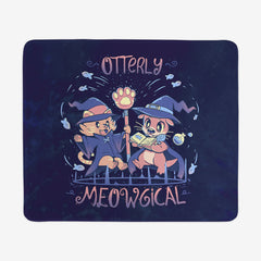 Extra large gaming mousepad of Otterly Meowgical by TechraNova. A cat and an otter dressed in witch hats and capes read from a spell book. Fish are swimming around them. 