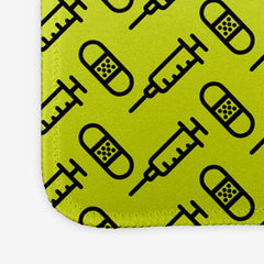 A close-up of the green extra large gaming mousepad with a black pattern of bandages and vaccines