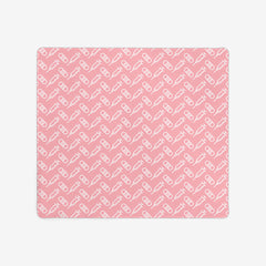 A pink extra large gaming mousepad with a white pattern of bandages and vaccines