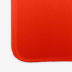 A close-up of a red extra large gaming mousepad.