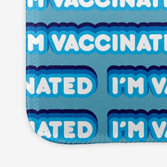 A close-up of a blue extra large gaming mousepad with a blue and white bubble text pattern. The text that reads “I’m Vaccinated” is in white. Each of these has blue behind them, from the lightest shade to the darkest shade.