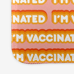 A close-up of a pink extra large gaming mousepad with an orange and white bubble text pattern. The text that reads “I’m Vaccinated” is in white. Each of these has orange behind them, from the lightest shade to the darkest shade.