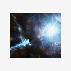 XL mousepad of Going Beyond Light by Martin Kaye. An abstract space scene. There is a large whit explosion to the right side of green, blue, and white stars.