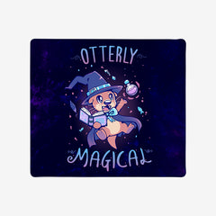 Large Gaming Mousepad of Otterly Magical by TechraNova. A cute otter in a witch hat and cape. It holds a book and a bottle. Fish and sparkles are around the otter. 