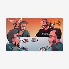 Draw For Turn Playmat by Draw For Turn. Four people sit around a table playing Magic The Gathering.