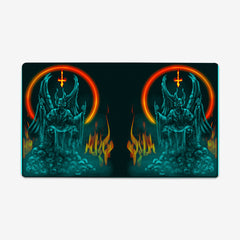 Wrong Heaven by Why Try Designs. On half of the playmat a blue and black demon sits on a throne on top of a pile of blue skulls. There is a ring of fire behind the demon creating a halo, and flames coming off of the skulls. This image is reflected on the other side of the playmat.