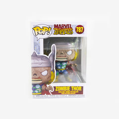 Front of the box for the Zombie Thor Funko Pop! figure. It shows zombie Thor, a figure with white eyes, wrinkly gray skin, and yellowed teeth. He is reaching out with both hands. He has bright yellow hair covered with a silver helmet. His clothes and cape have holes in them showing rotting flesh. 